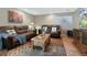 Cozy living room featuring comfortable seating, a stylish rug, and ample natural light at 6 Woodland Cir, Highlands Ranch, CO 80126