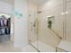 Modern shower with glass door, rainfall shower head, and accessible grab bar at 6 Woodland Cir, Highlands Ranch, CO 80126