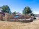 Community entrance sign with brick wall and landscaping, creating a welcoming first impression at 6 Woodland Cir, Highlands Ranch, CO 80126