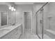 Bright bathroom with double sinks, white countertops, and a glass shower door at 6211 W 28Th Ct, Wheat Ridge, CO 80214