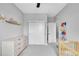 Neutral Bedroom with a dresser, crib, double door closet, and light grey carpet at 6211 W 28Th Ct, Wheat Ridge, CO 80214