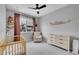 Neutral Bedroom features a crib, dresser, decor, and rocker, with an outside view at 6211 W 28Th Ct, Wheat Ridge, CO 80214