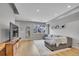 Well-lit living room showcasing hardwood floors, a gray sectional, and large windows at 6211 W 28Th Ct, Wheat Ridge, CO 80214