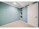 Finished basement with built-in shelving, carpeted flooring and neutral colors at 9674 Fox Den Dr, Littleton, CO 80125