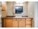 Bathroom vanity with ample counter space, storage cabinets, and mirrored medicine cabinet at 9674 Fox Den Dr, Littleton, CO 80125