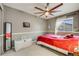Comfortable bedroom featuring a ceiling fan, white trim and a large window at 9674 Fox Den Dr, Littleton, CO 80125