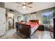 Inviting bedroom with hardwood floors, a ceiling fan, and ample natural light from multiple windows at 9674 Fox Den Dr, Littleton, CO 80125