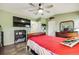 Comfortable bedroom featuring hardwood floors, ceiling fan, and ample closet space for storage at 9674 Fox Den Dr, Littleton, CO 80125