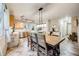 Dining area adjacent to the kitchen, featuring a wooden table and chairs at 9674 Fox Den Dr, Littleton, CO 80125