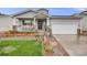 Charming home with a welcoming porch, stone accents, lovely landscaping and a well-maintained lawn at 9674 Fox Den Dr, Littleton, CO 80125