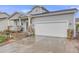 Exterior view of this home with its attached two-car garage and stone facade and beautiful lawn at 9674 Fox Den Dr, Littleton, CO 80125