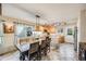 Charming kitchen featuring tile floors, wooden cabinetry, a center island, and an adjacent dining area at 9674 Fox Den Dr, Littleton, CO 80125