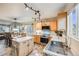Stylish kitchen with stainless steel appliances, tile flooring, wooden cabinets, and a cozy dining area nearby at 9674 Fox Den Dr, Littleton, CO 80125