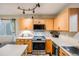 Bright kitchen with modern appliances, wooden cabinets, white countertops, and a view of the outdoors at 9674 Fox Den Dr, Littleton, CO 80125