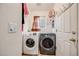 Functional laundry room equipped with a washer, dryer, and storage solutions for efficient organization at 9674 Fox Den Dr, Littleton, CO 80125