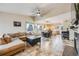 Open floor plan featuring living room, dining area, and kitchen with vaulted ceilings at 9674 Fox Den Dr, Littleton, CO 80125