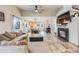 Inviting living room with tile floors, fireplace, and an open layout to the kitchen and dining area at 9674 Fox Den Dr, Littleton, CO 80125