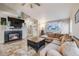 Cozy living room with a fireplace, tile floors, and comfortable seating at 9674 Fox Den Dr, Littleton, CO 80125