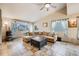 Bright living room with tile floors, vaulted ceiling, and comfortable seating at 9674 Fox Den Dr, Littleton, CO 80125