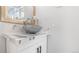 Stylish powder room featuring marble countertop, vessel sink, and modern vanity with brushed silver accents at 555 Everett St, Lakewood, CO 80226