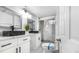 Modern bathroom boasts double vanity with black sinks and a walk-in glass shower at 555 Everett St, Lakewood, CO 80226