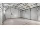 The interior of the steel frame garage with concrete flooring is a spacious blank canvas ready to be personalized at 555 Everett St, Lakewood, CO 80226