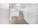 Finished basement hallway showcases plank flooring and a staircase to the left at 555 Everett St, Lakewood, CO 80226
