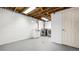 Unfinished basement laundry area features a practical sink, modern washer and dryer, and exposed ceiling beams at 555 Everett St, Lakewood, CO 80226
