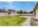 Large backyard featuring a lawn, concrete patio, gravel and white fence at 5770 Waverley Ave, Firestone, CO 80504