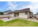 Spacious backyard featuring a well-manicured lawn, concrete patio with firepit, and solar panels at 5770 Waverley Ave, Firestone, CO 80504
