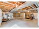 Unfinished basement featuring exposed pipes, a furnace, and new construction framing at 5770 Waverley Ave, Firestone, CO 80504