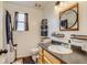 Bright bathroom features a wood vanity with granite countertop, and modern fixtures and mirror at 5770 Waverley Ave, Firestone, CO 80504