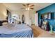 Comfortable bedroom with carpet flooring, a ceiling fan, and natural light from the large windows at 5770 Waverley Ave, Firestone, CO 80504