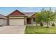 Charming single-Gathering home featuring a well-maintained lawn, two-car garage, and a welcoming front porch at 5770 Waverley Ave, Firestone, CO 80504