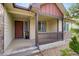 Inviting front porch with a brown door, stone accents, and manicured landscaping at 5770 Waverley Ave, Firestone, CO 80504