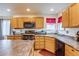 Well-lit kitchen featuring wooden cabinets, stainless steel appliances, and durable countertops at 5770 Waverley Ave, Firestone, CO 80504