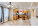 Open concept kitchen with light wood cabinets, an island with seating, and plenty of natural light at 5770 Waverley Ave, Firestone, CO 80504