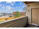 Balcony view overlooking landscaped grounds, community parking, and blue skies at 7468 S Alkire St # 204, Littleton, CO 80127