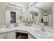 Bright bathroom featuring double sinks, large mirrors, and stylish decor at 7468 S Alkire St # 204, Littleton, CO 80127