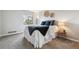 Comfortable bedroom featuring a large window, carpeting, and a well-made bed at 7468 S Alkire St # 204, Littleton, CO 80127