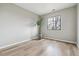 Sunlit room with wood floors, a large window, and a decorative plant at 7468 S Alkire St # 204, Littleton, CO 80127