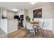 Eat-in kitchen and adjacent dining area, featuring white cabinets and a charming table at 7468 S Alkire St # 204, Littleton, CO 80127