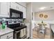 Modern kitchen with stainless steel appliances and eat-in dining area with natural light at 7468 S Alkire St # 204, Littleton, CO 80127