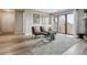 Bright living room showcasing balcony access, neutral paint, wood floors, and contemporary furnishings at 7468 S Alkire St # 204, Littleton, CO 80127