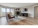 Cozy living room featuring a stone fireplace, balcony access, and modern furnishings at 7468 S Alkire St # 204, Littleton, CO 80127