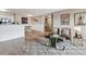 Open-concept living room featuring modern decor, including stylish seating and hardwood floors at 7468 S Alkire St # 204, Littleton, CO 80127