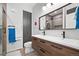 Modern bathroom featuring a double sink vanity, elegant mirror, walk-in glass shower and modern fixtures at 84 Spruce St # 707, Denver, CO 80230