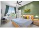 Bright bedroom boasts a ceiling fan, large window, ample closet space, and moss art at 84 Spruce St # 707, Denver, CO 80230