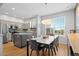 Bright dining area connected to the kitchen, featuring a modern table and stylish pendant lighting at 84 Spruce St # 707, Denver, CO 80230