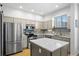 Modern kitchen featuring stainless steel appliances, an island, and ample cabinet space at 84 Spruce St # 707, Denver, CO 80230